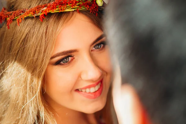 Amazing bride with a charming smile looks at her husband — Stock Photo, Image