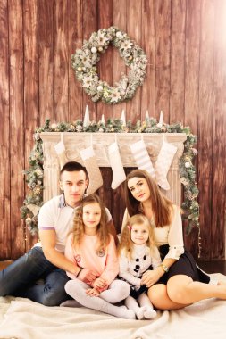 anne, baba ve iki kızı şömine de vakit geçirmekten zevk