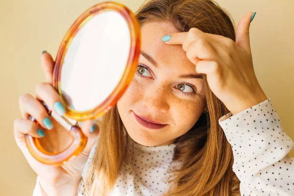 Shocked Woman Looking At Pimple On Forehead In Mirror.