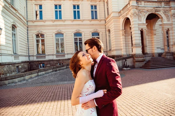 Flüstert der Bräutigam der Braut ein Geheimnis ins Ohr, in das sie lacht — Stockfoto