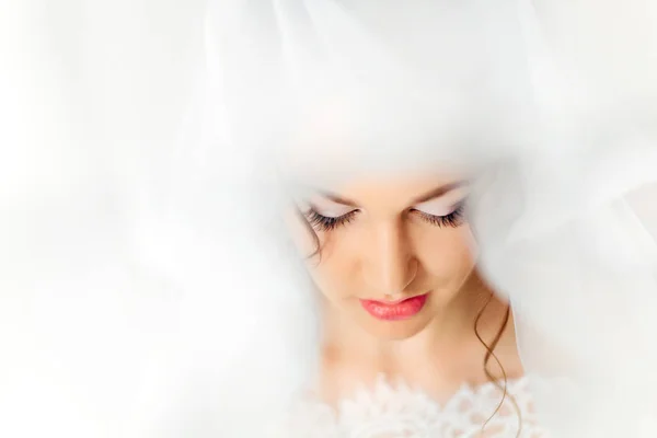 Gentle makeup of a young girl wrapped in tulle — Stock Photo, Image