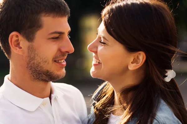 a close-up of a couple in love who look at each other and smile