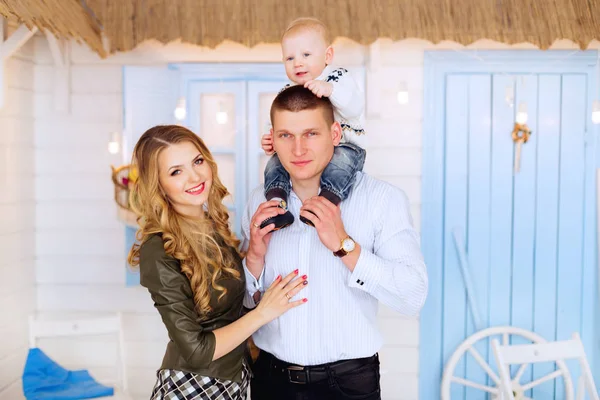 a close-up of a happy family on the background a white house wit