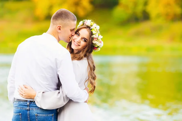 Menina bonita com cabelos longos e uma grinalda de flores em sua hea — Fotografia de Stock