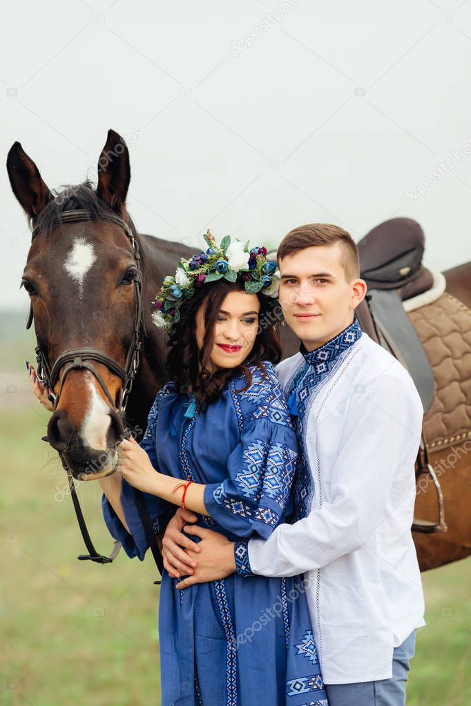 The boyfriend hugs a dreamed girlfriend who holds a horse for a 