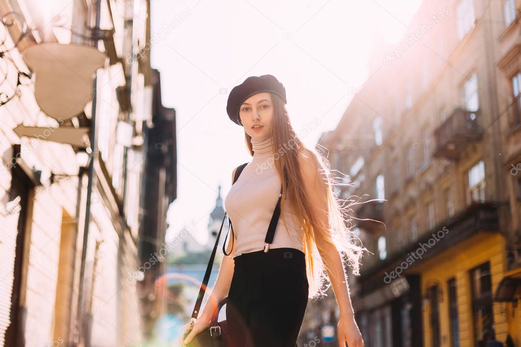 Close-up of a girl dressed in french style on the street of the 