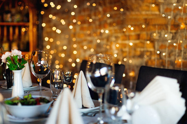 Wine glasses for different drinks on the table against the backg