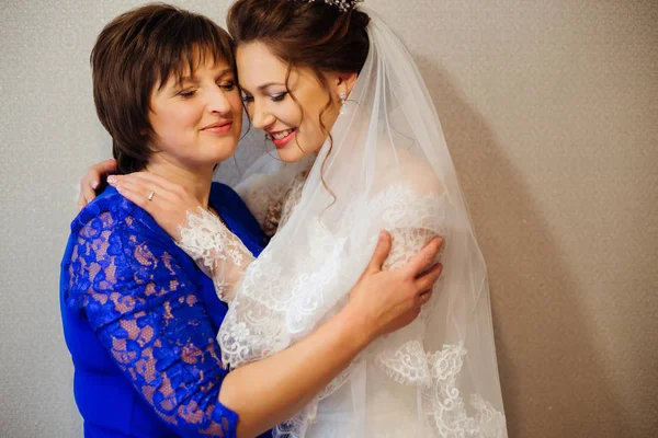 mother and daughter gently hugging and closed her eyes before the wedding ceremony