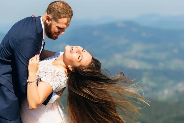 Close-up van pasgetrouwden die plezier hebben. De bruidegom omarmt haar bruid — Stockfoto