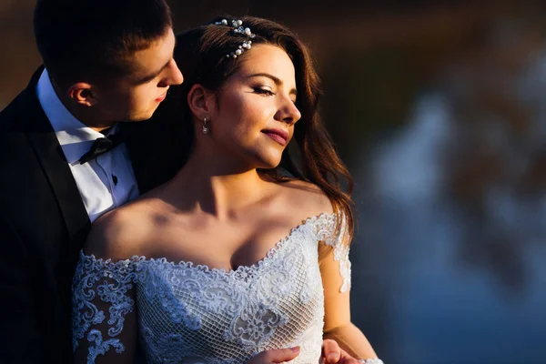 Elegante Braut mit wunderschönem Make-up und Kleid mit Spitze. Bräutigam i — Stockfoto