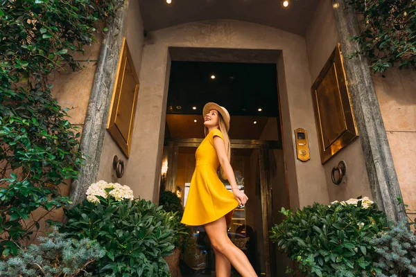 Young beautiful stylish girl posing near a building with a glass — 스톡 사진