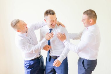 groom and groomsmen in stylish white shirts and blue pants. frie clipart