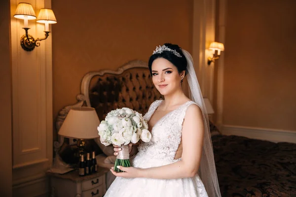 Невеста в красивом свадебном платье держит свадебный букет и l — стоковое фото