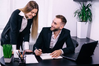 Ofiste çalışan gülümseyen müdür ve sekreter. takım çalışması konsepti