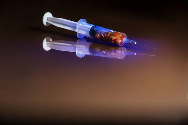 a needle syringe containing metals and unknown substances relate