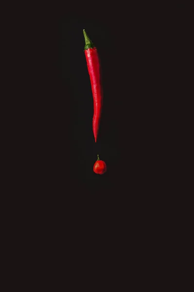 exclamation point made with chillies on dark background