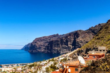 Magnificent views of The Gigants cliffs and the Port of Santiago from the Achipenque Lookout. April 13, 2019. Santiago Port, Santa Cruz De Tenerife Spain Africa. Travel Tourism Street Photography.