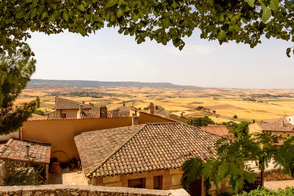 Wonderful views of the roofs of medieval houses of Hita with a green frame of tree branches. July 23, 2019. Hita Guadalajara Castilla La Mancha. Spain. Travel Tourism Holidays