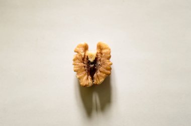 Soyulmuş ceviz, beyaz bir arka planda ortadan ikiye bölünmüş. Kalp için sağlıklı yiyecek..