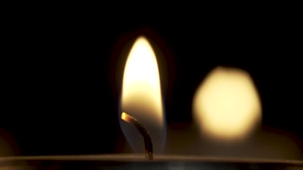 The wick of a burning candle and the waving of a flame — ストック動画