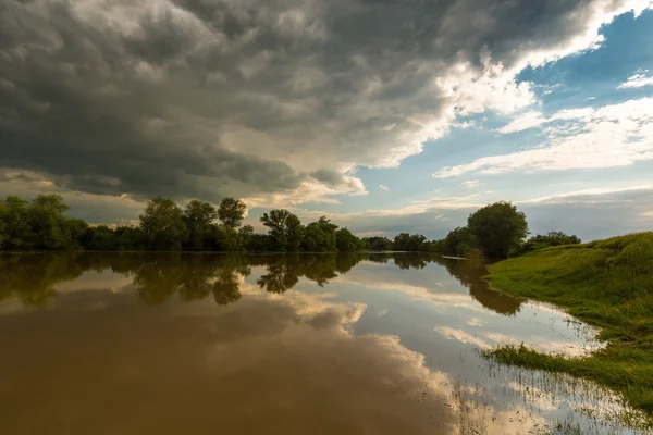 Ominous stormy sky over natural river