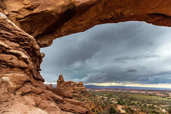 Dramatic storm clouds and rain in the desert, in the Arches National Park, in autumn