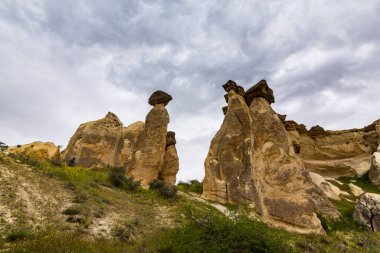 Türkiye 'nin Kapadokya kentindeki dramatik fırtına bulutları altında kireçtaşı kaya oluşumları