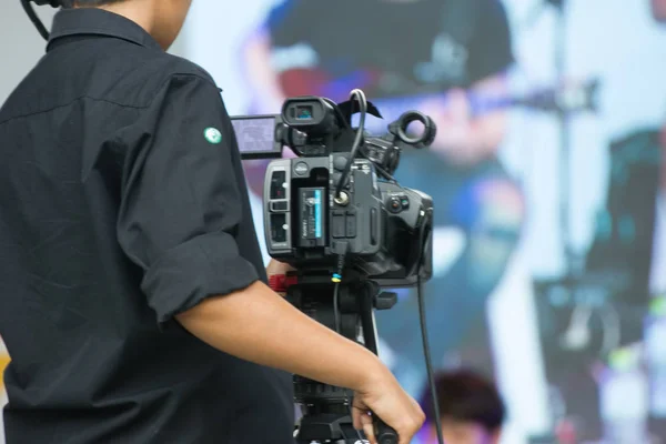 professional cameraman - covering on event with a video