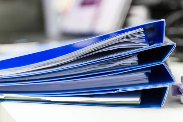 Closeup - file folder and Stack of business report paper file on the table in a work office