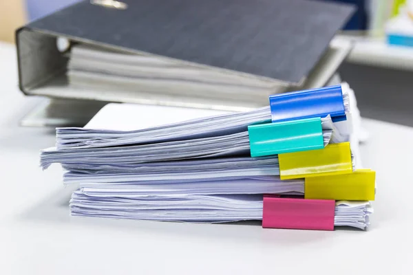 Stack of papers documents in archives files with paper clips on desk at offices, business concept.