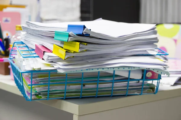 Stack of papers documents in archives files with paper clips on desk at offices, business concept.