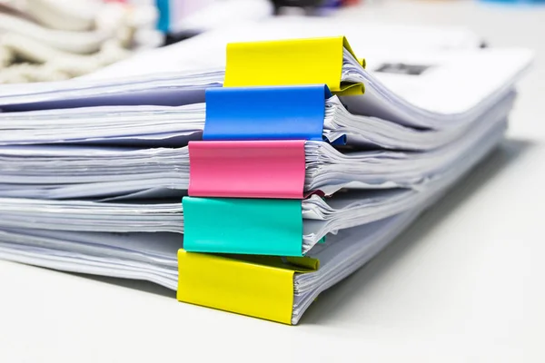 Stack of papers documents in archives files with paper clips on desk at offices, business concept.