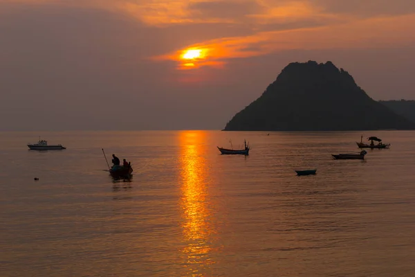 Sea View Landscape the ocean and boat at sunrise time orange color and mountains on the horizon at Ao Manow Prachuap Khiri Khan, Thailand