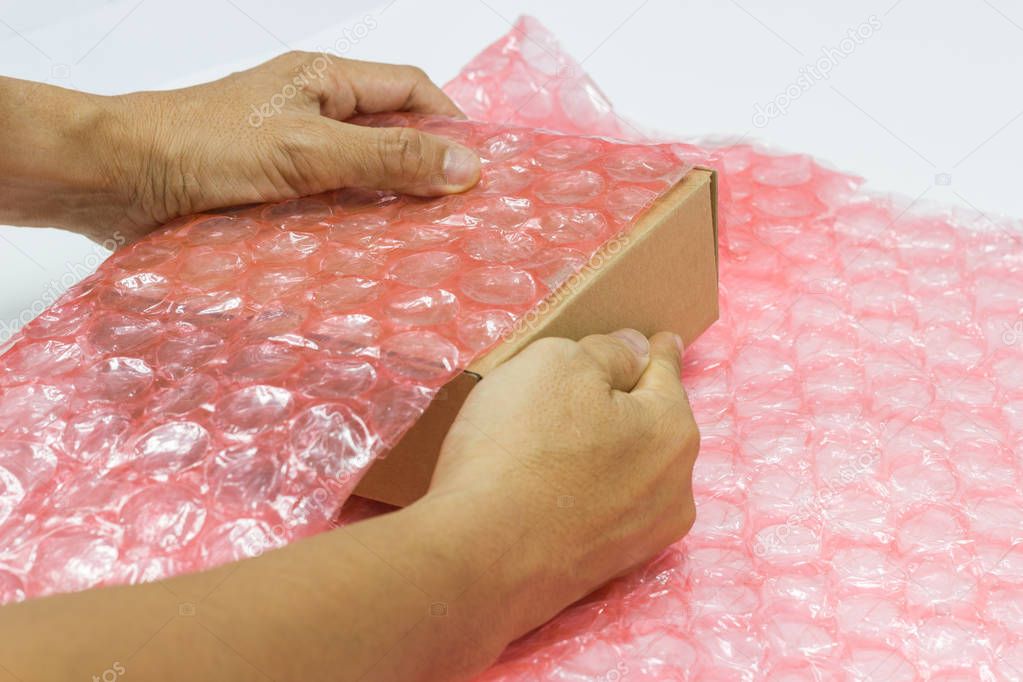 Man hands bubble wrap, product protection covering insurance, Anti-fracture damaged during shipping.