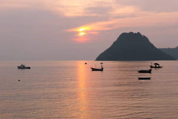 Sea View Landscape the ocean and boat at sunrise time orange color and mountains on the horizon at Ao Manow Prachuap Khiri Khan, Thailand