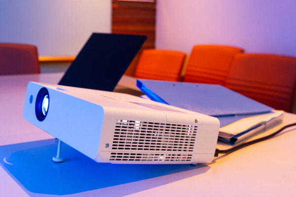 projector connected to Laptop for presentation in a meeting room with files folder and files document on table, business concept.