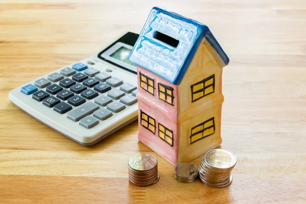 Model house with calculator, concept Buying a house, residence, business, finance