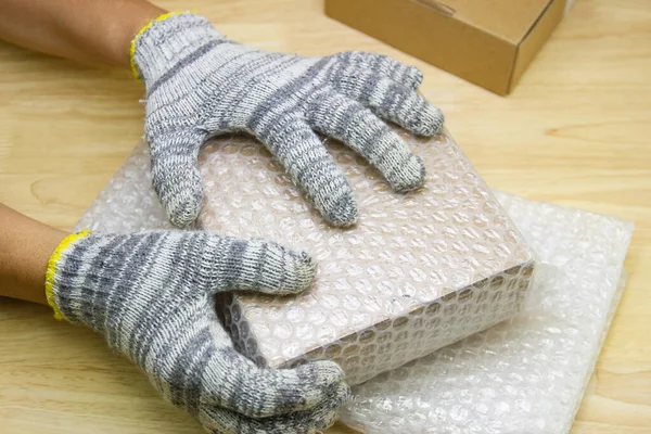 hand of man hold bubble wrap, for protection parcel product cracked or insurance During transit