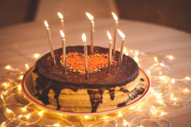 Home made cake with candles and decorated with red heart.