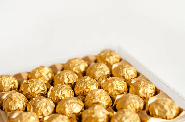 Box Candies Wrapped Golden Foil White Background Luxury Food — Stock Photo, Image