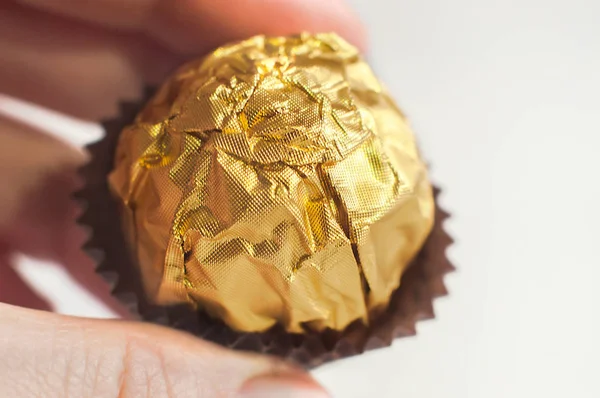 Candy Wrapped Golden Foil Human Hand Macro Shot — Stock Photo, Image