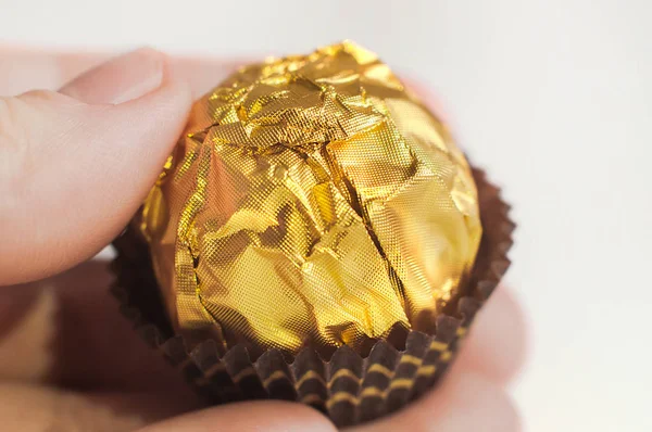 Candy Wrapped Golden Foil Human Hand Macro Shot — Stock Photo, Image