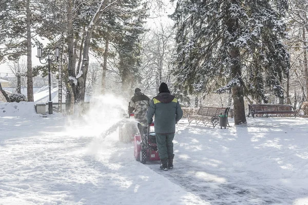 Sneeuwruimen in het stadspark. — Stockfoto