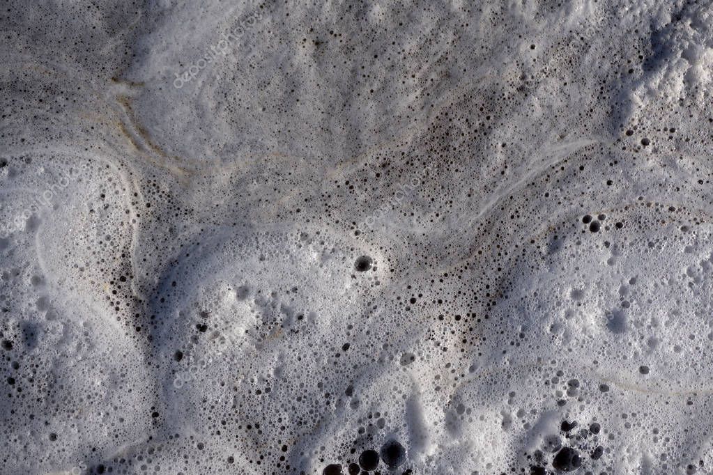 White foam on water and waves background texture, gray river froth