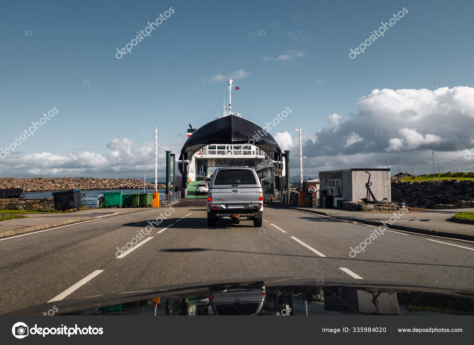 Cars driving on the ferry at Mortavika that is transporting them to
