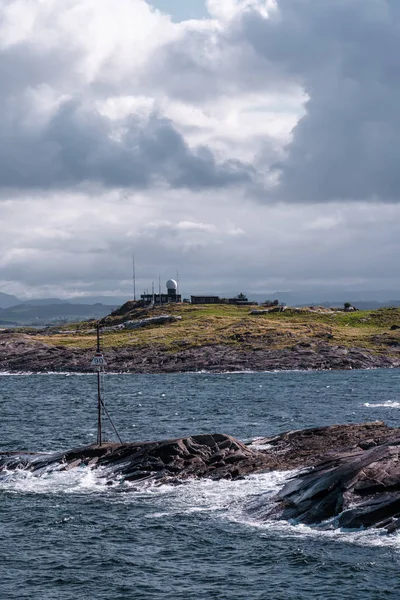 Harsh sea at Mortavika and the weather or radar station on the small hill, Norway