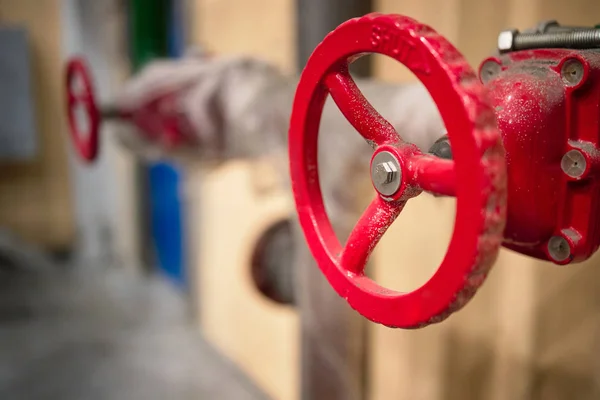Red valves on hydrant pipelines of security and fire extinguishing systems of modern chemical production with copy space