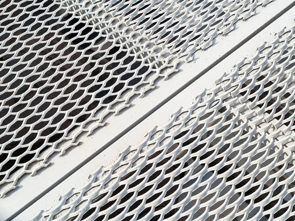 Perforated metal sheet stamping plates texture angled view. Made through metal stamping sheet metal manufacturing lightweight elements to loadbearing structural combine strength functionality