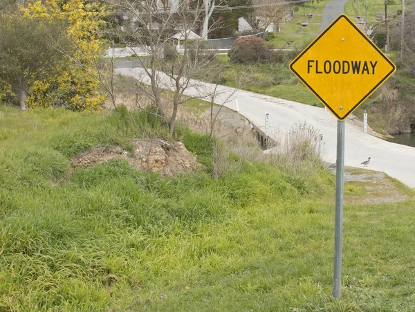 A black and yellow 'floodway' sign depicting a floodway zone — Stock Photo, Image