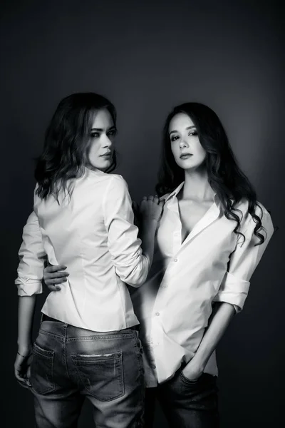 Deux belles filles posant en chemise blanche et en jeans — Photo